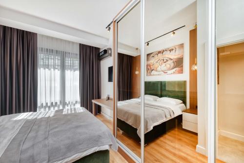 a bedroom with a bed and a glass wall at PRO HOME SUİTES in Istanbul