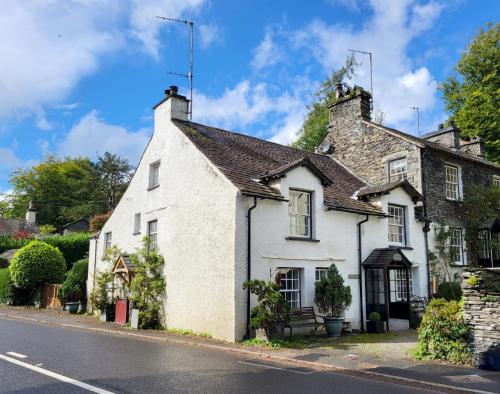 an old white house on the side of a street at Wayside Cottage Clappersgate Ambleside in Ambleside