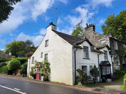 a white house on the side of a street at Wayside Cottage Clappersgate Ambleside in Ambleside