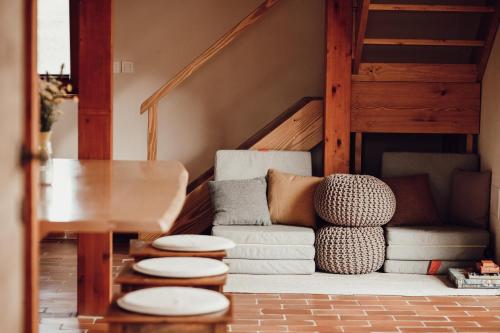 a living room with a couch and a table at Ecological farm Makrobios Panonija in Gornji Petrovci