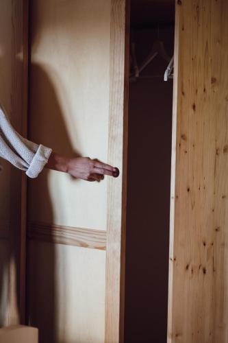 a persons hand is sticking out of a door at Ecological farm Makrobios Panonija in Gornji Petrovci