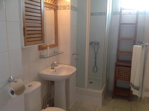 a bathroom with a toilet and a sink and a shower at Le chant du Diamant calme vue mer et plage à 50 m in Le Diamant