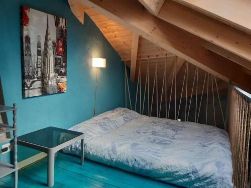 a bed with a glass table in a room at Hortà - Charming Attic with Rooftop Lake View in Lezzeno