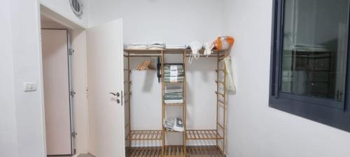 a room with two shelves and a ladder at Amazing apartment in Bat Yam