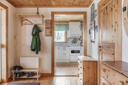 a kitchen with wooden walls and wooden flooring at Unique cottage with a view of Malaren, Mariefred in Mariefred