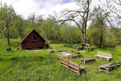 a group of benches in front of a cabin at Friendship Cabin (Friendship Land) in Şelari