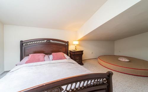 a bedroom with a large bed and a table and lamp at Hotel Na Skalkách in Nový Jičín