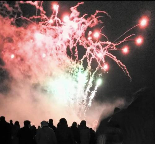 a crowd of people watching a fire show with fireworks at Brocks in Bath