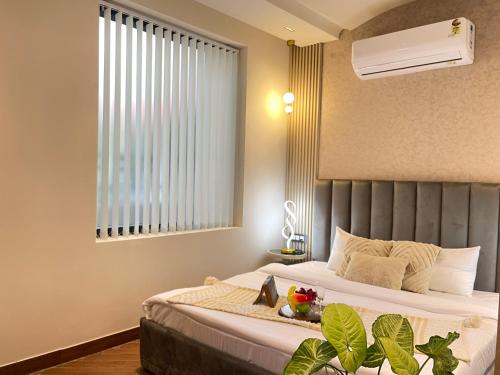 a hotel room with a bed and a window at Bedchambers, Saket in New Delhi