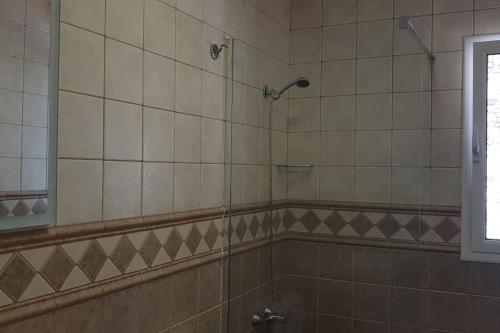a bathroom with a shower and a mirror at West Corner Caleta de Fuste in Caleta De Fuste