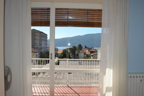 a window with a view of a city at SUNA HOLIDAY in Verbania