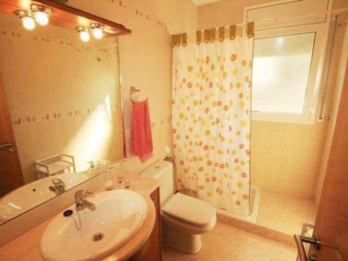 a bathroom with a sink and a toilet and a shower at Villa L'Ametlla de Mar, 5 pièces, 8 personnes - HISP-217-20 in L'Ametlla de Mar
