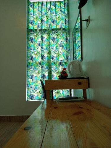 a room with a table and a window with a curtain at BBoutique Hotel in Lapu Lapu City