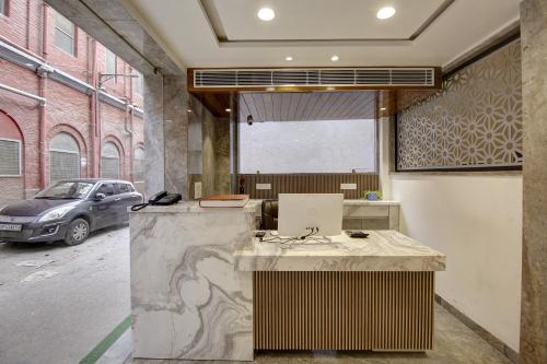 an office with a desk with a laptop on it at Hotel Kaca Inn-by Haveliya Hotels in New Delhi