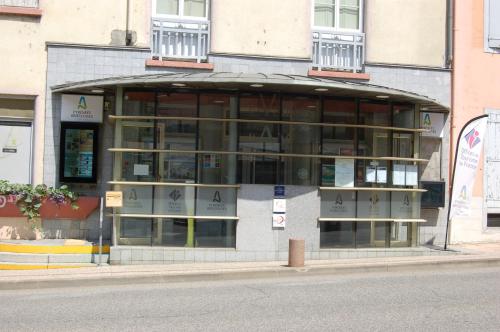 a building with a lot of windows on a street at Studio La LAUZE in Ax-les-Thermes