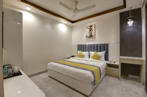 a hotel room with a bed and a bathroom at Hotel Kaca Inn-Traveller's Choice Awarded Best of the Best 2025 in New Delhi