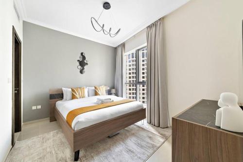 Postel nebo postele na pokoji v ubytování StoneTree - Near JBR Beach - Prime Location