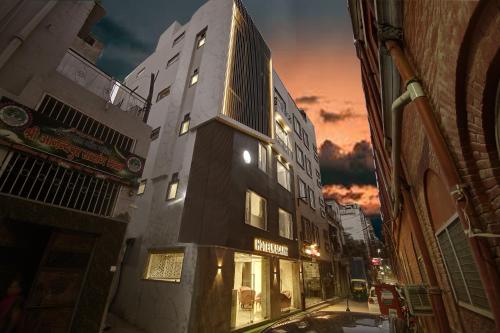 a building on the side of a street at night at Hotel Kaca Inn-Traveller's Choice Awarded Best of the Best 2025 in New Delhi