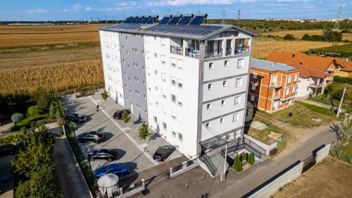an overhead view of a white building with solar panels on it at ForS Resort & Spa in Belgrade