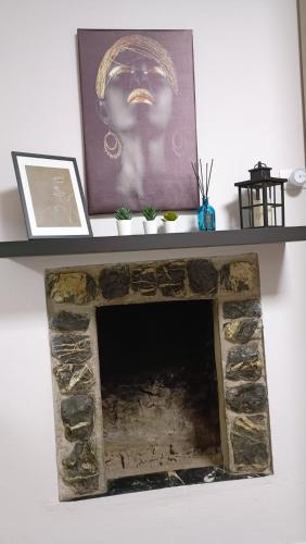 a fireplace with a picture on top of it at 20 VENTI in Angolo Terme