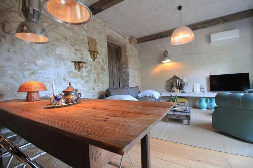 a living room with a wooden table and a couch at Villa Cornelia, Ponte de Lima in Ponte de Lima