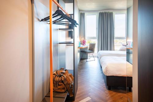 a room with a bunk bed and a backpack in it at LOGINN Hotel Waiblingen in Waiblingen
