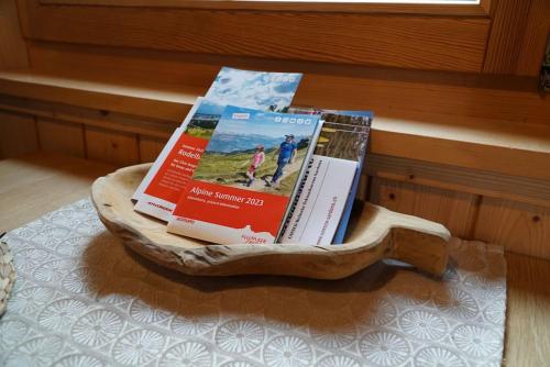 a pile of books sitting on top of a table at Chalet Terza in Quarten