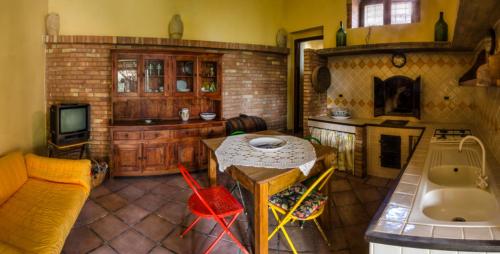 a living room with a couch and a table and a fireplace at Casale il Pozzo in Sciacca