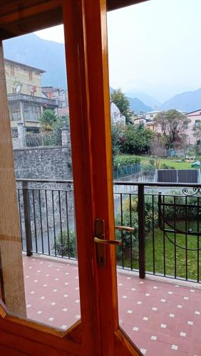 a door to a balcony with a view of a building at 20 VENTI in Angolo Terme