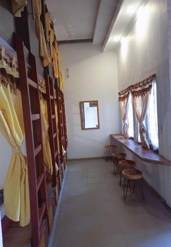 a room with a row of chairs and a row of windows at ZEN MOON Hostel in Yogyakarta