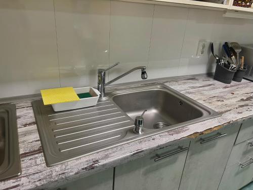 a kitchen sink with a faucet on top of it at Demeevsky Hostel in Kyiv