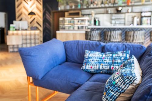 a blue couch in a store with pillows on it at LOGINN Hotel Waiblingen in Waiblingen