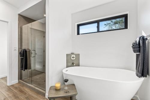 a white bathroom with a tub and a shower at Modern Luxury Home in the Heart of West Sedona in Sedona