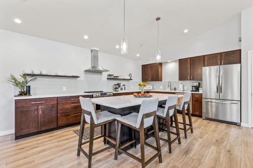 a kitchen with a table and chairs and a refrigerator at Modern Luxury Home in West Sedona with Hot Tub in Sedona