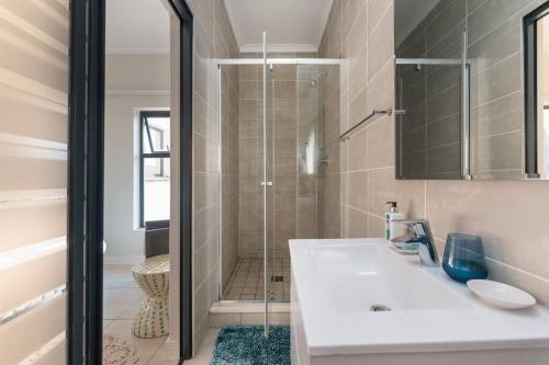a bathroom with a sink and a shower at 864 Ballito Hillis Luxury Estate Family Apartment in Ballito
