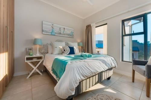 a bedroom with a bed and a table and a window at 864 Ballito Hillis Luxury Estate Family Apartment in Ballito