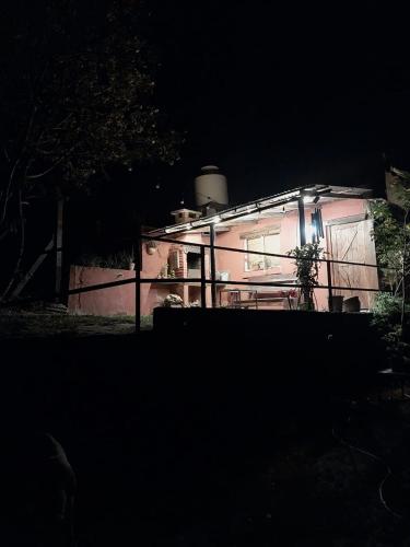a house lit up at night in the dark at Aguaribay cabañas in San Javier