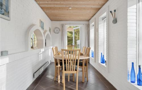 a dining room with a table and chairs at 3 Bedroom Amazing Home In Ålbæk in Ålbæk