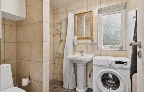 a bathroom with a washing machine and a sink at 3 Bedroom Amazing Home In Ålbæk in Ålbæk