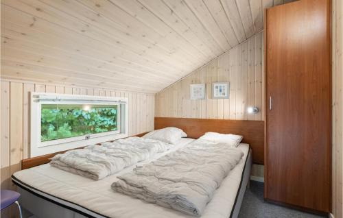 ブラーバンドにあるStunning Home In Blvand With 3 Bedrooms, Sauna And Wifiの木製の天井の客室のベッド1台分です。