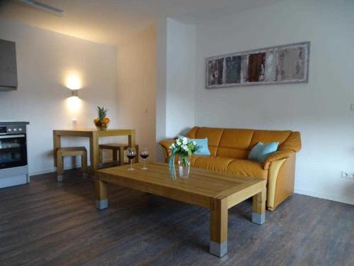 a living room with a couch and a coffee table at Ohlerich Speicher App_ 42 in Wismar
