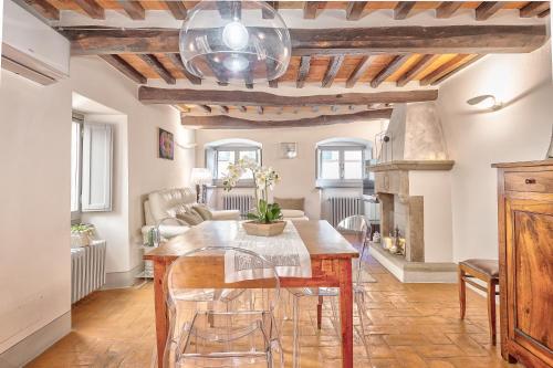 une salle à manger avec une table et une cheminée dans l'établissement Casa Samuela - Together in Tuscany, à Cortone