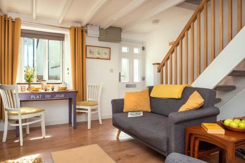 a living room with a couch and a table at Country Cottage - Apple Pie Luxury Escapes in Bere Alston
