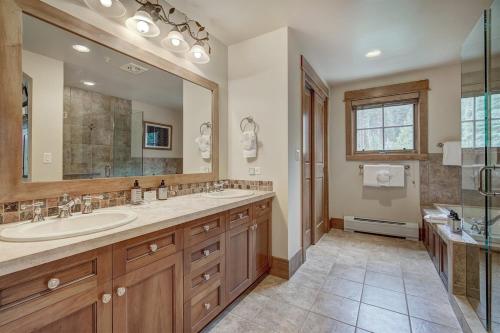 a bathroom with a sink and a large mirror at Lone Eagle Ski In Ski Out Condo in Dillon