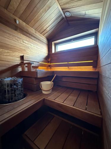 a small sauna with a window and a tub at HolySuites 2 - Ski-in and out apartment in the middle of ski slopes in Pyhä in Pyhätunturi