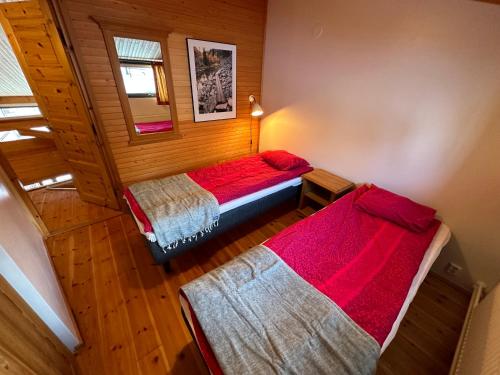 an attic bedroom with two beds in a room at HolySuites 2 - Ski-in and out apartment in the middle of ski slopes in Pyhä in Pyhätunturi