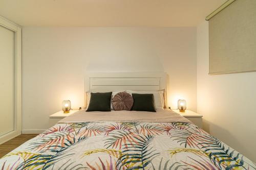 a bedroom with a large bed with two lamps at Valdes Center Los Cristianos in Los Cristianos