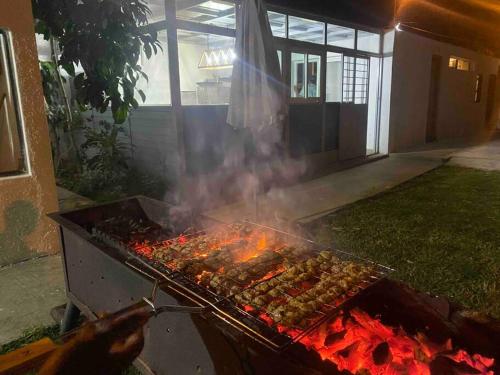 a person is cooking food on a grill at Logement entier et indépendant D in Rabat