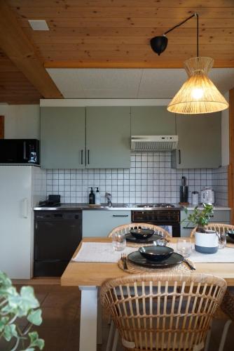 a kitchen with a table with chairs and a light at Chalet Terza in Quarten