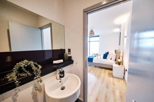 a bathroom with a sink and a mirror at Pluxa Nordic Sky - Spacious Manchester Gem 2Bed 2bath, & free parking in Manchester